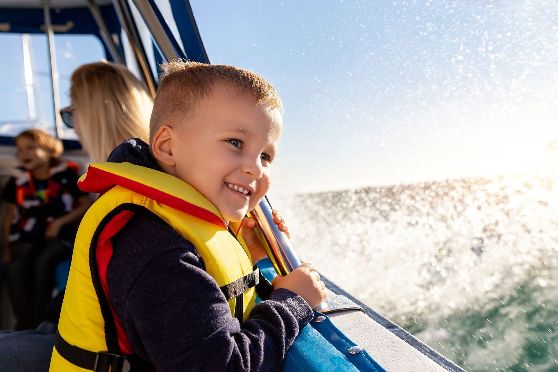 A smiling child enjoying a family boat rental on Lake Anna